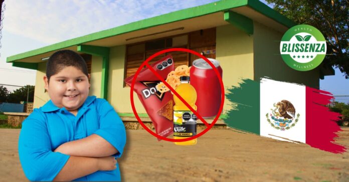 An overweight kid in Mexico posing with banned junk food in his school